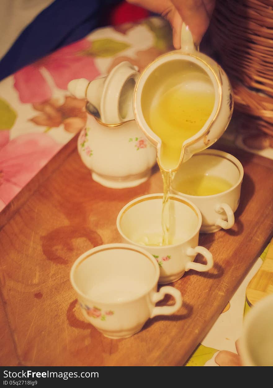 Horizontal photo, of the teapot tea flow in cup, tea ceremony