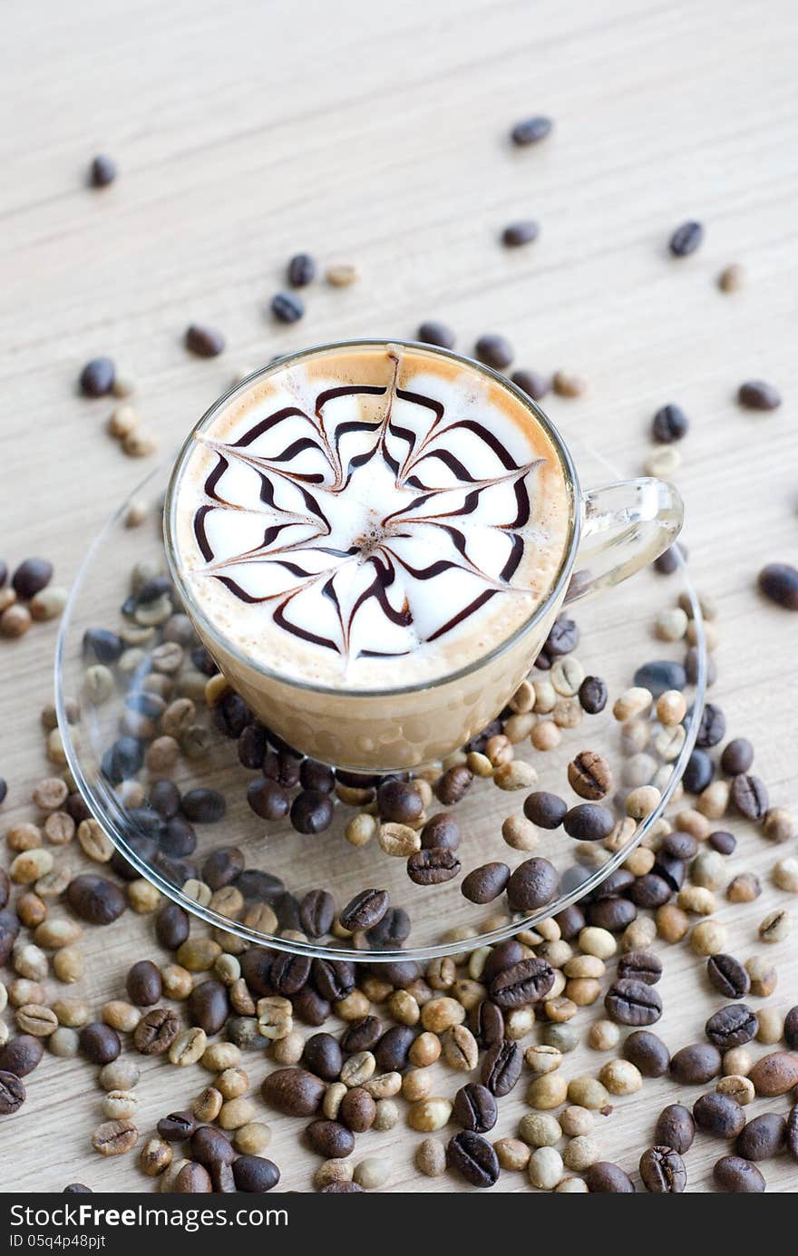 Verticle latte art with coffee beans on table. Verticle latte art with coffee beans on table