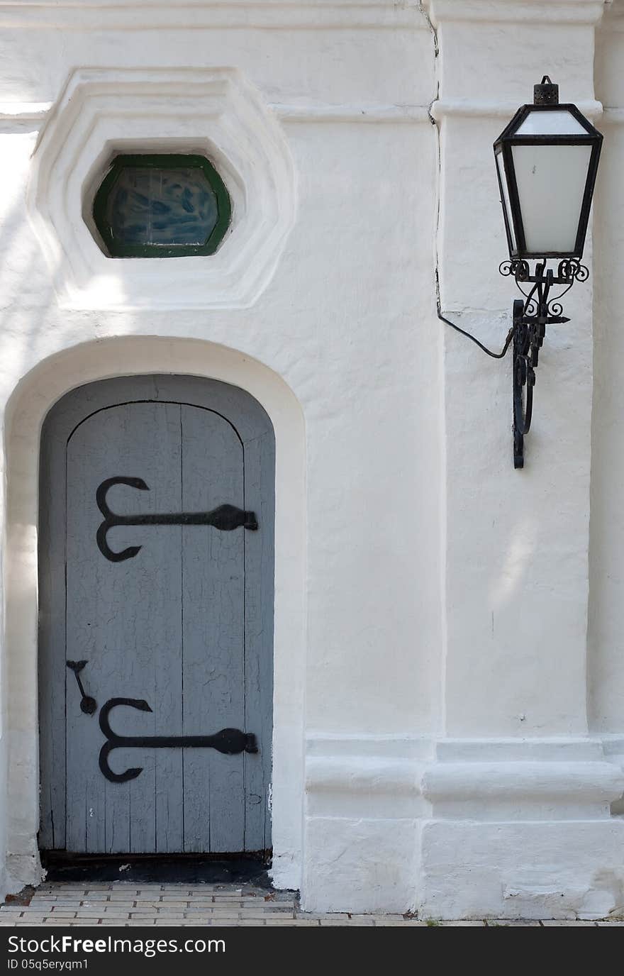 Ancient door with a lamp .