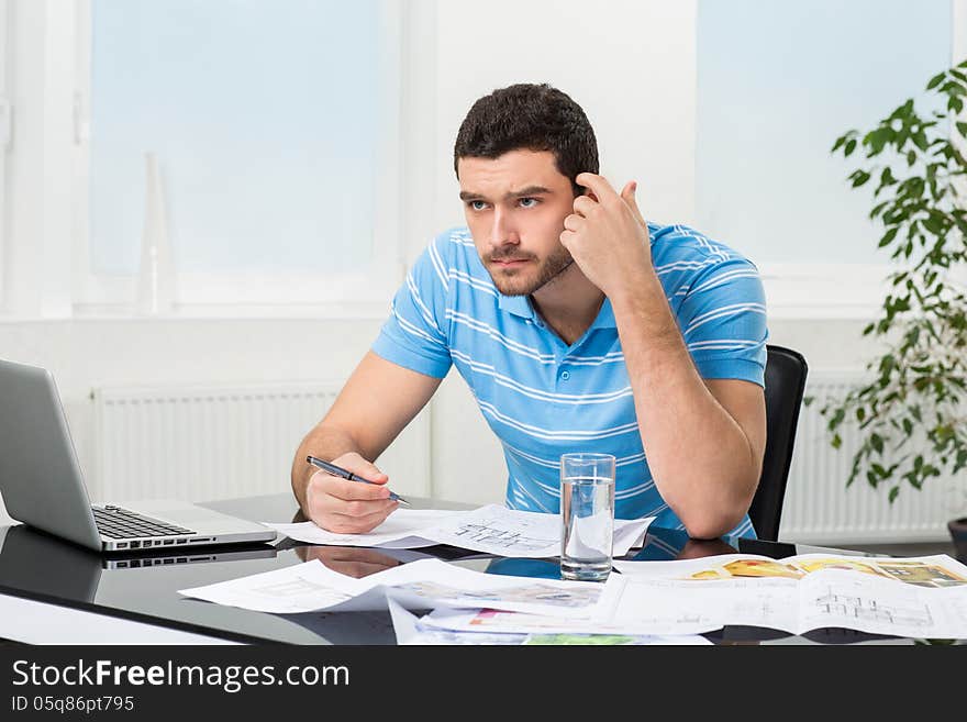 Handsome Young Interior Designer At Workplace