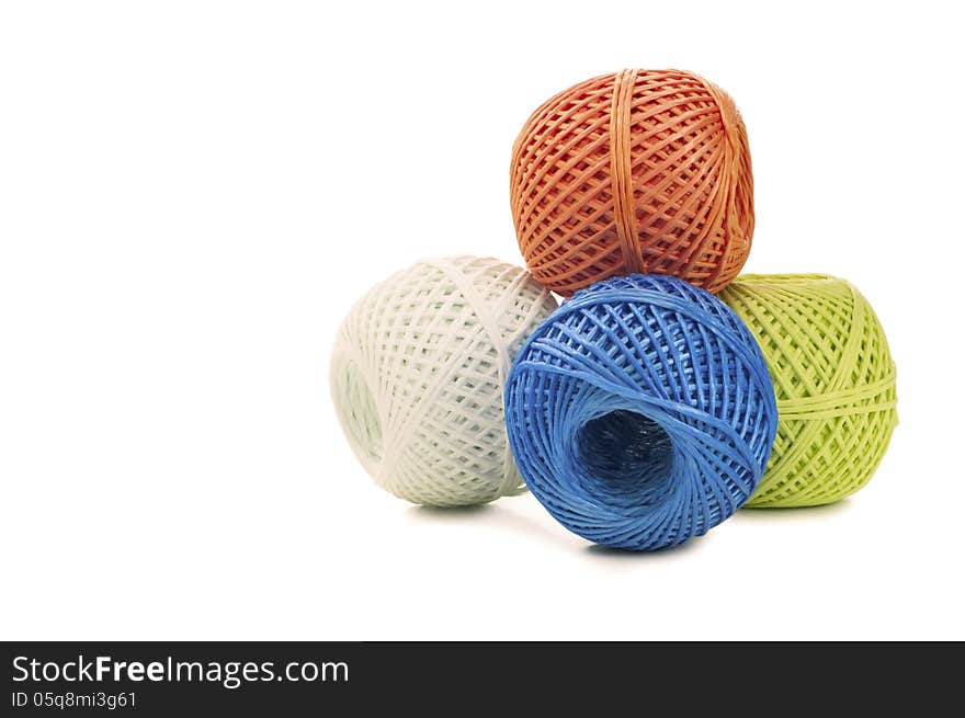 Different colored skeins twine on a white background