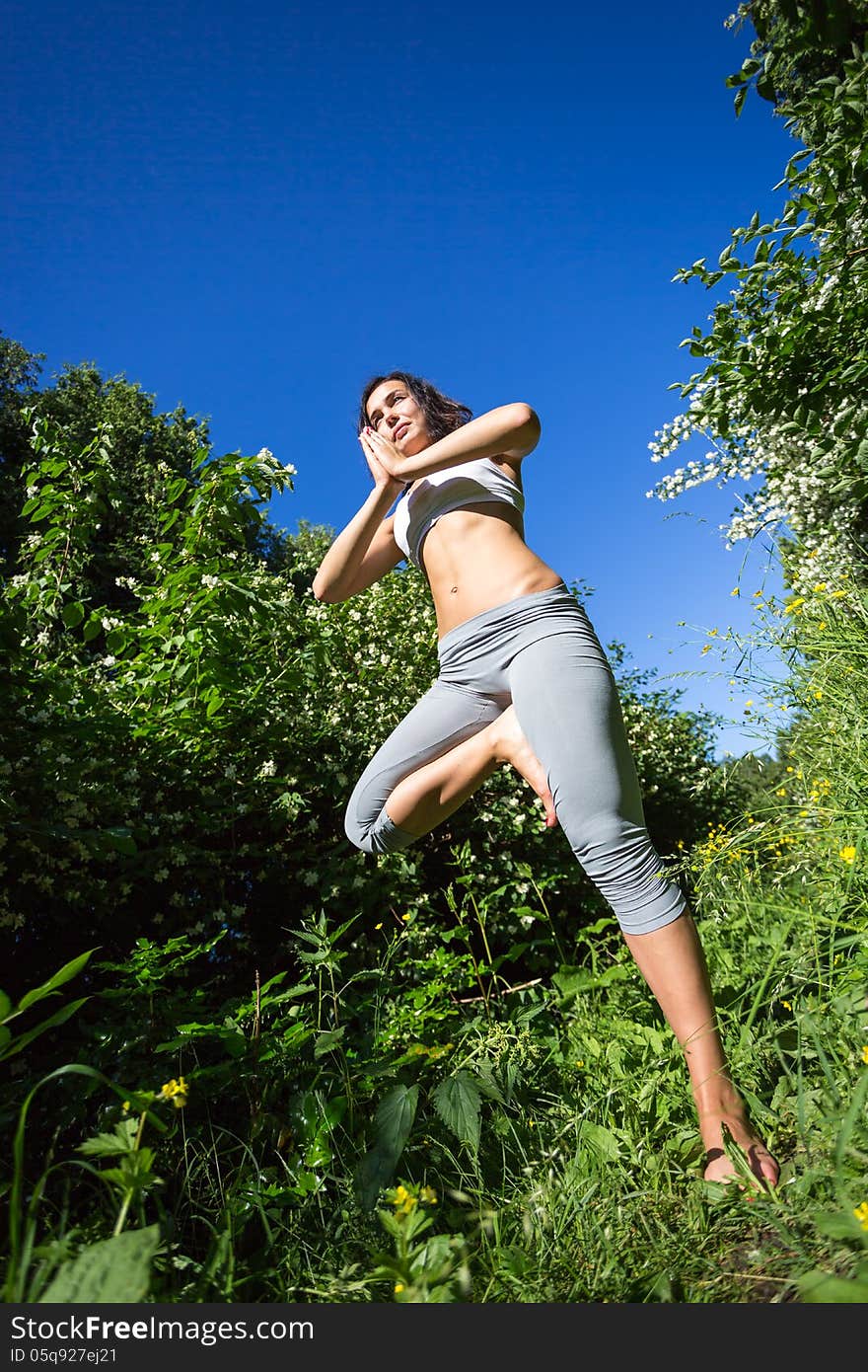 Young woman doing yoga outdoor