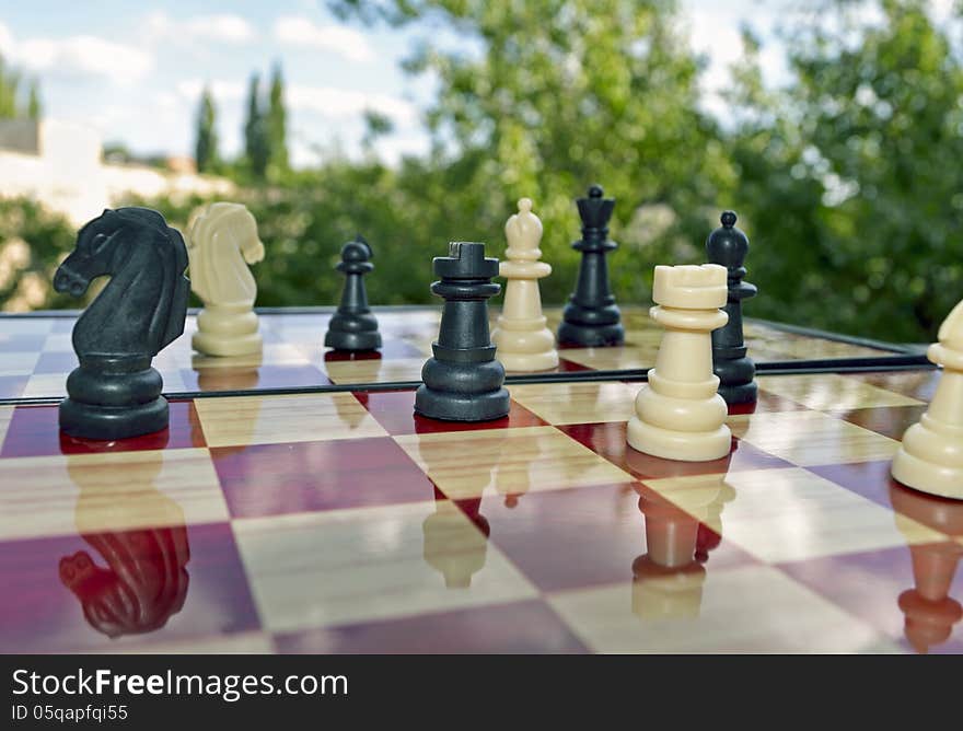 The photo shows chess board with black and white pieces.