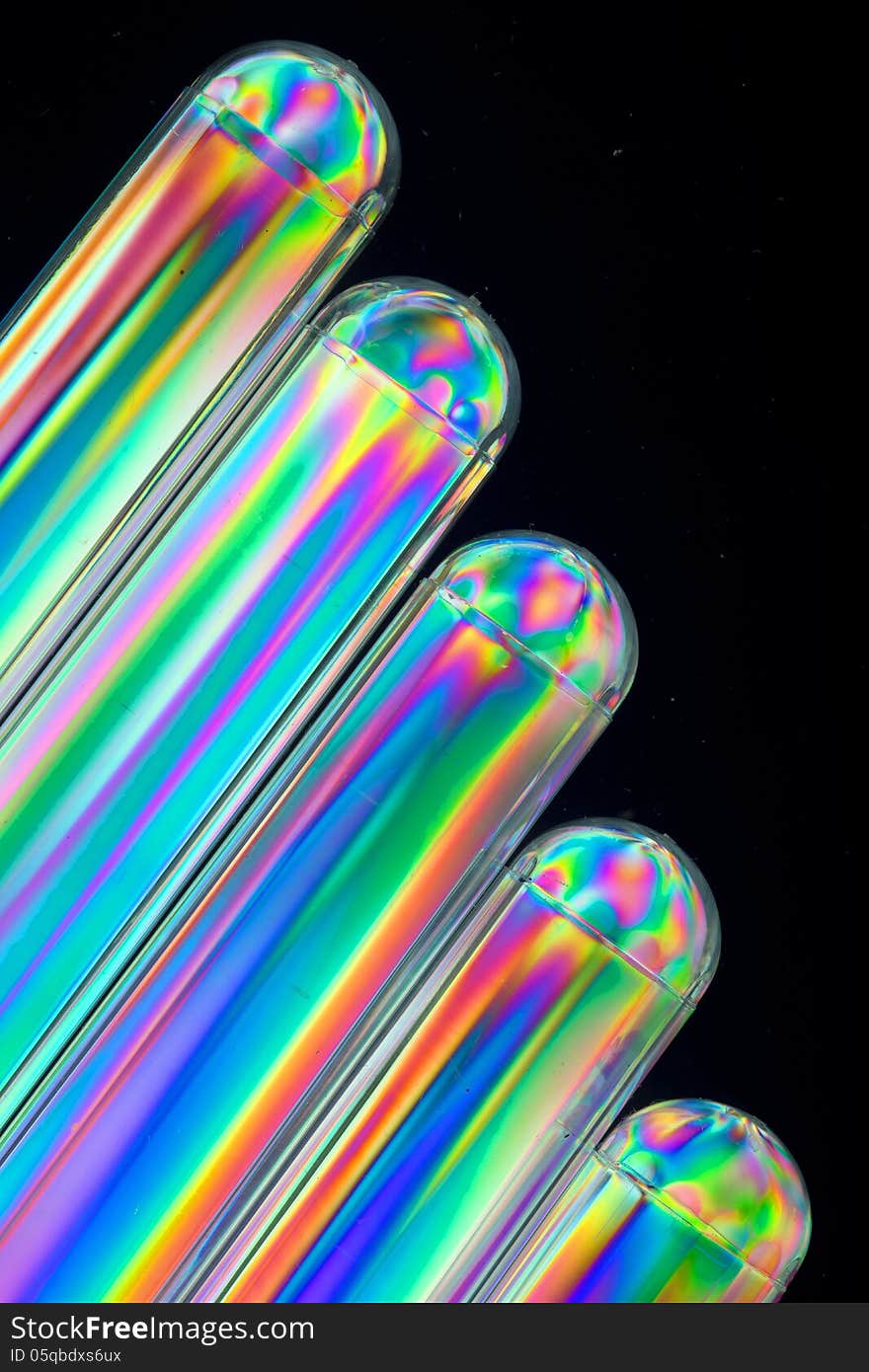 Tubes consisting of transparent plastic, used as brandy-glasses seen through polarised light, which gives them vivid colors. The tubes are arranged in the picture as a diagonal cataract. Tubes consisting of transparent plastic, used as brandy-glasses seen through polarised light, which gives them vivid colors. The tubes are arranged in the picture as a diagonal cataract