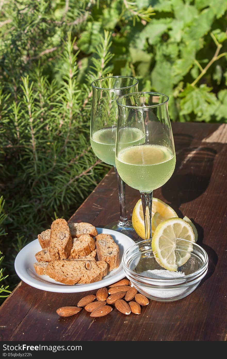 Limoncello - Italian lemon liqueur typically served with biscotti - oblong-shaped almond biscuits. Limoncello - Italian lemon liqueur typically served with biscotti - oblong-shaped almond biscuits