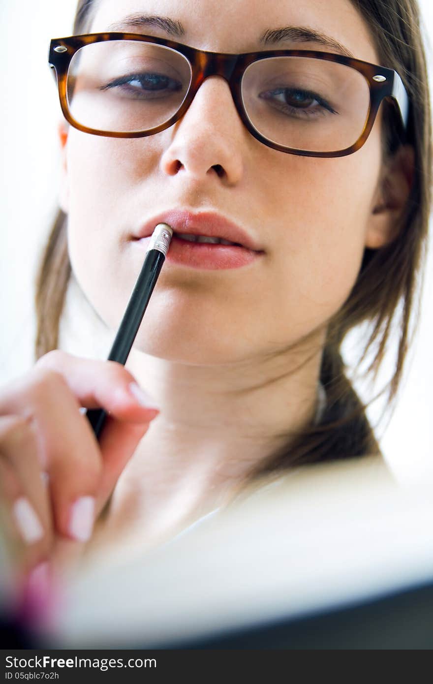 Young woman taking notes at home