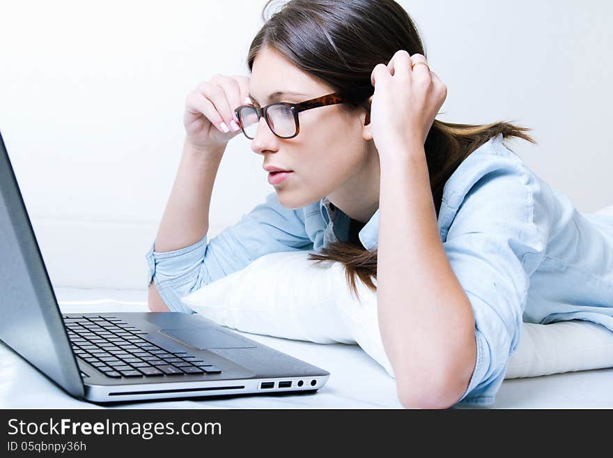 Young woman using her laptop at home