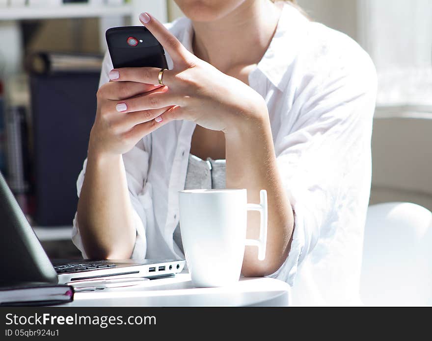 Woman talking on mobile phone at work