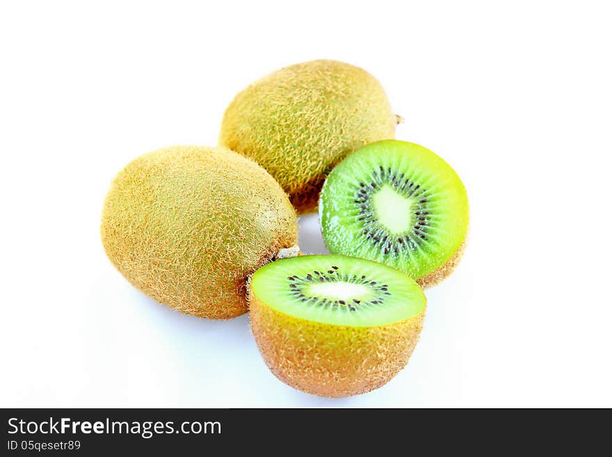 Ripe kiwi fruit sliced on a white background