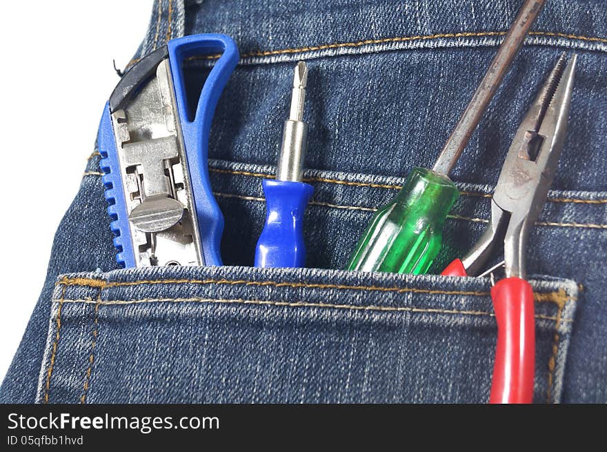 Knife,screw, pincer and cutterin jean's pocket on white background. Knife,screw, pincer and cutterin jean's pocket on white background