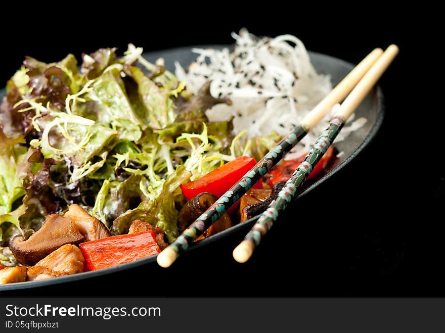 Healthy Japanese salad on the black plate