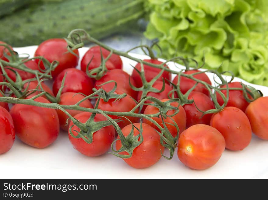 Cherry tomatoes cucumber salad on the tablecloth