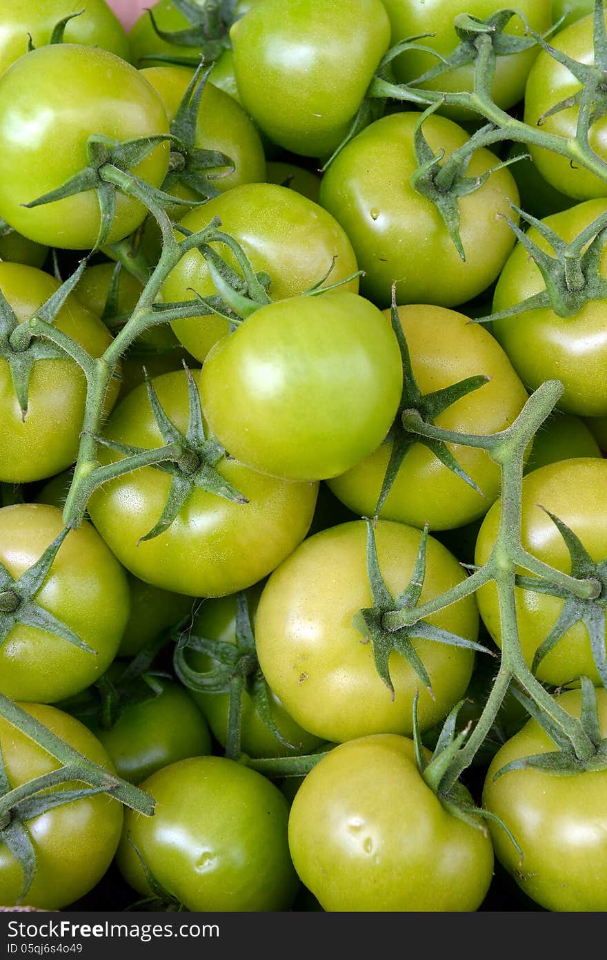 Green tomatoes on the counter of the store