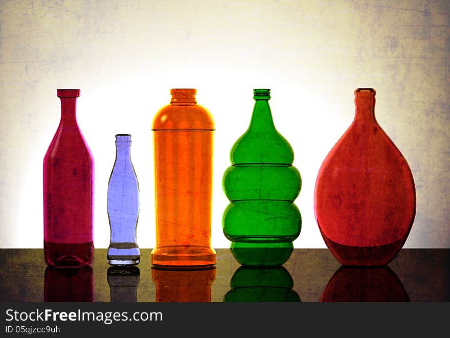 Isolated Glassware Lit from Behind. Various colors, different sizes.