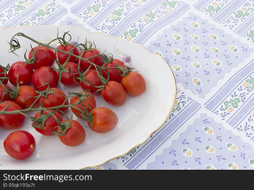 Cherry tomatoes plate tablecloth blue striped flower picture red and green agriculture