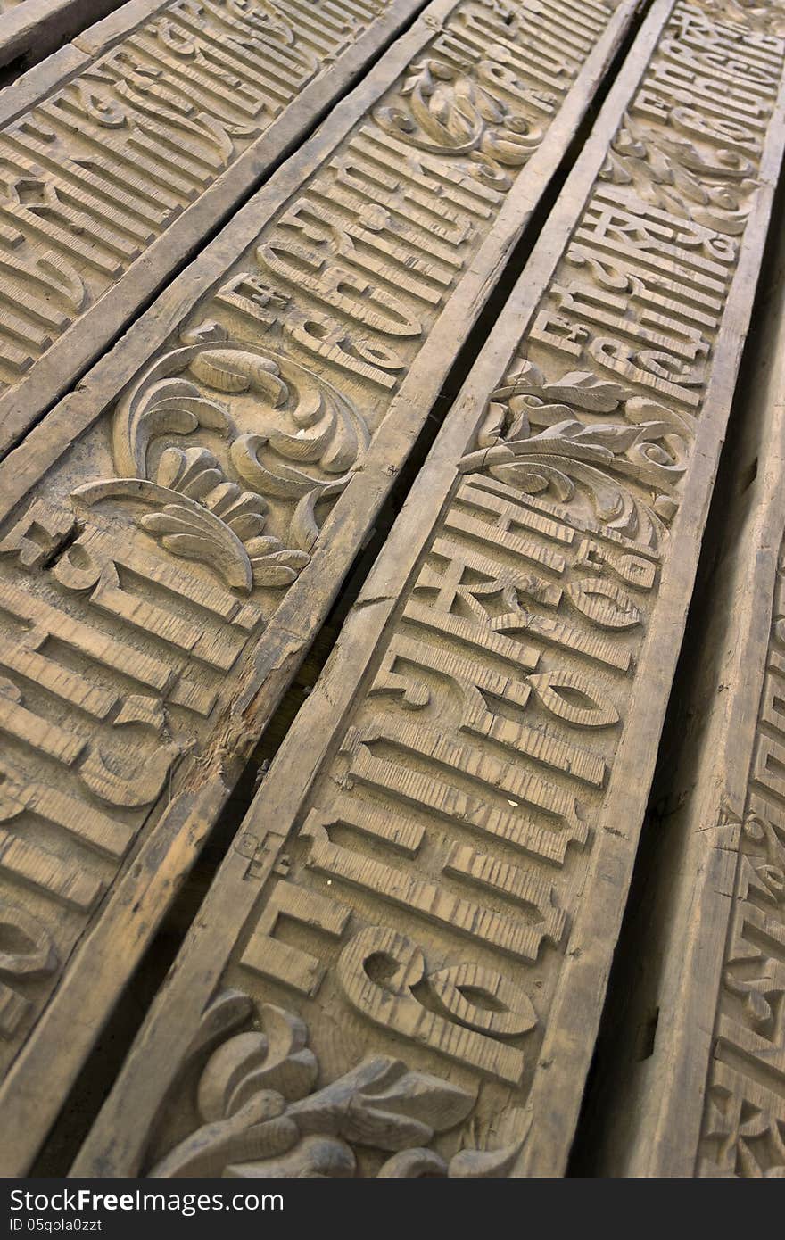 Text on wooden boards cut a letter to the religion of the ancient yellow beige brown background. Text on wooden boards cut a letter to the religion of the ancient yellow beige brown background