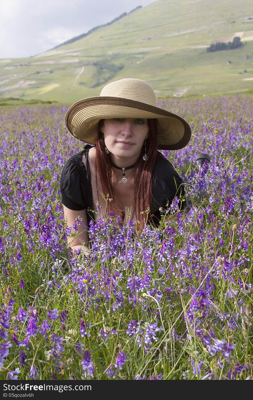 Portrait of fashion woman on violet flowers. Portrait of fashion woman on violet flowers.