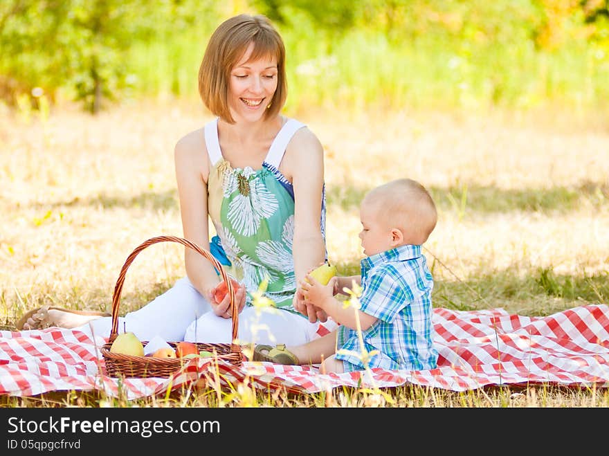 Mom and son have a picnic. This image has attached release.