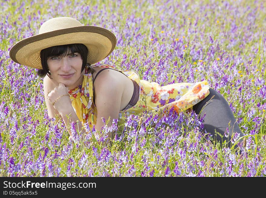 Brunette Lying Among Violet Flowers