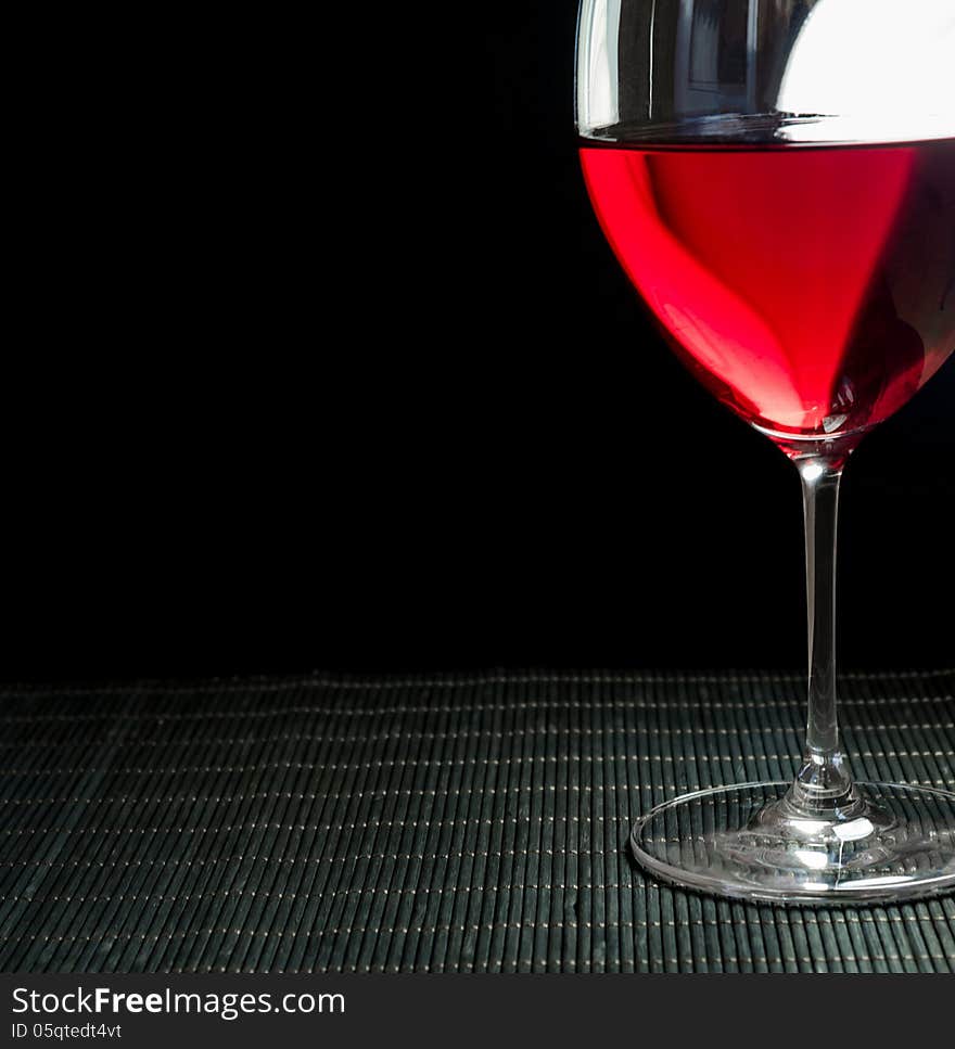 Wineglass with red wine, grey background