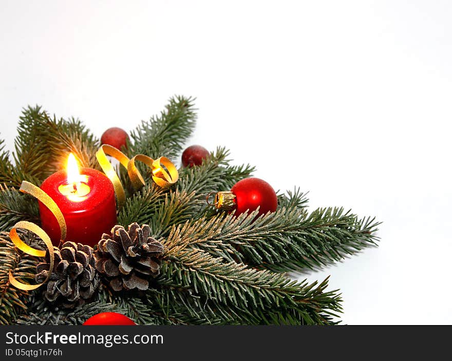 Red candle burning amongst twigs of the spruce. Red candle burning amongst twigs of the spruce