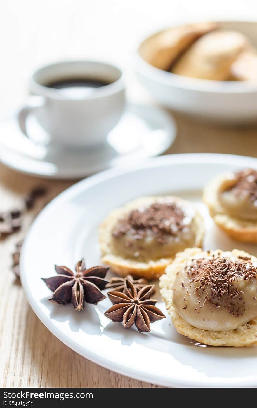 Scone with custard and cup of coffee