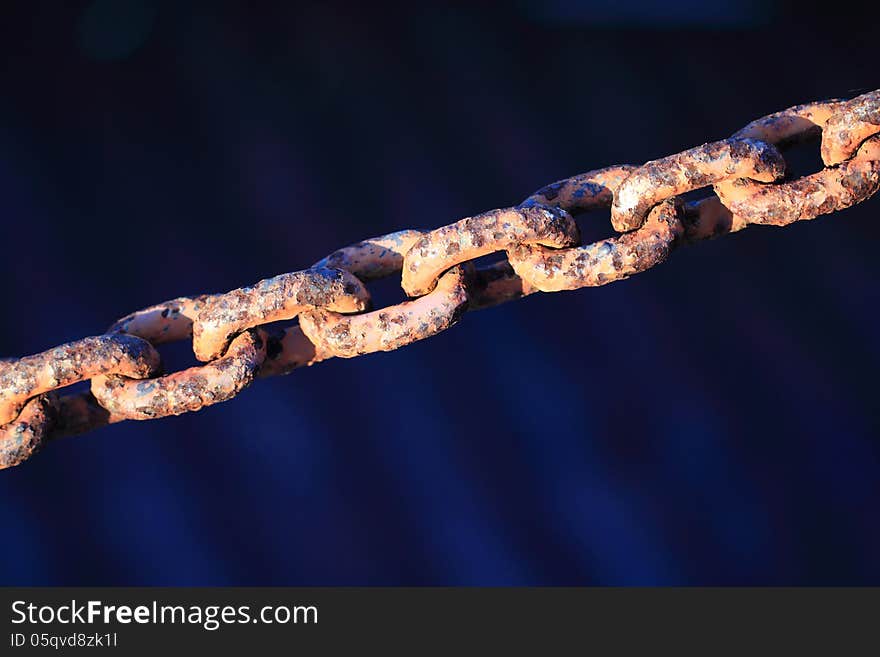 Rust old chain with dark blue in the background