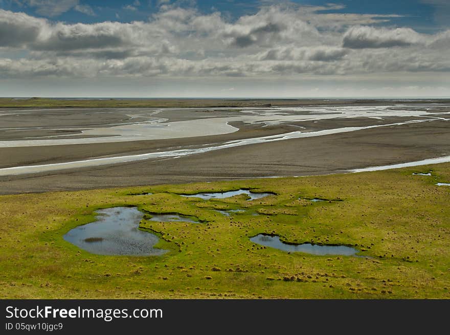 Little lake and the river delta on bright day in Iceland. Little lake and the river delta on bright day in Iceland