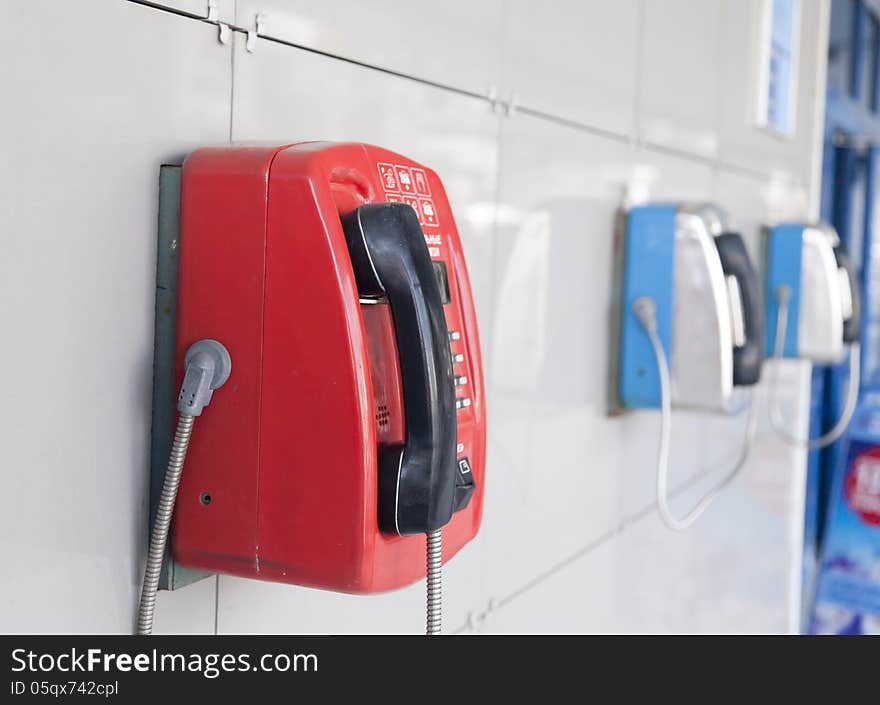 Payphones on a wall waiting for calls and people