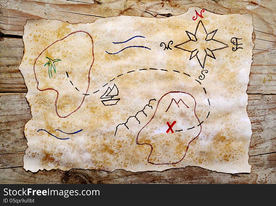 Treasure map on aged paper and wooden background. Treasure map on aged paper and wooden background