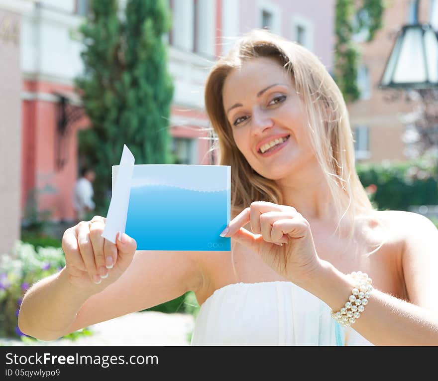 Young woman holding a blue card. Young woman holding a blue card