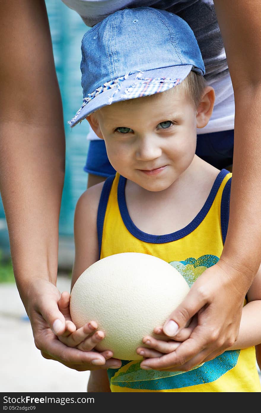 Little Boy Holding An Ostrich Eggj