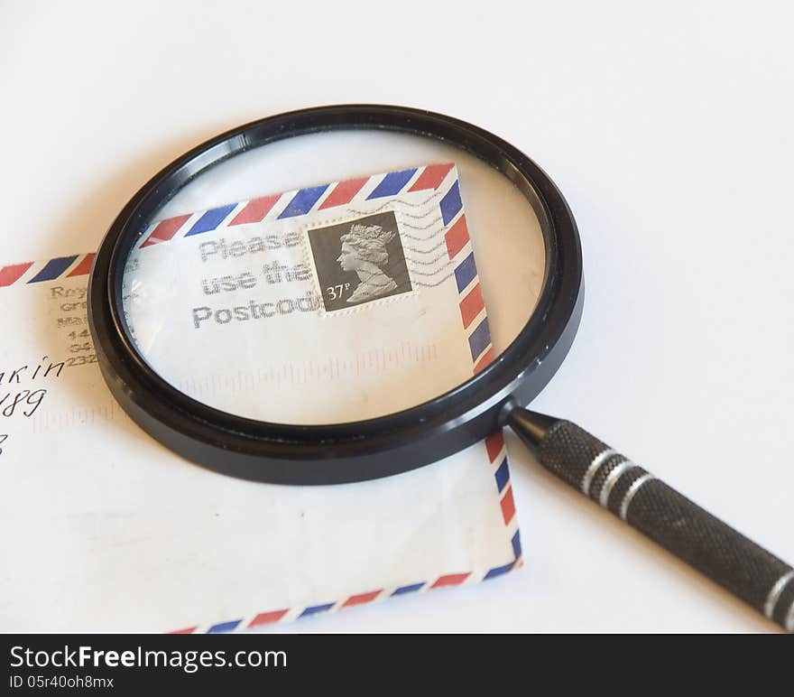 Magnifying glass on an envelope with a postage stamp