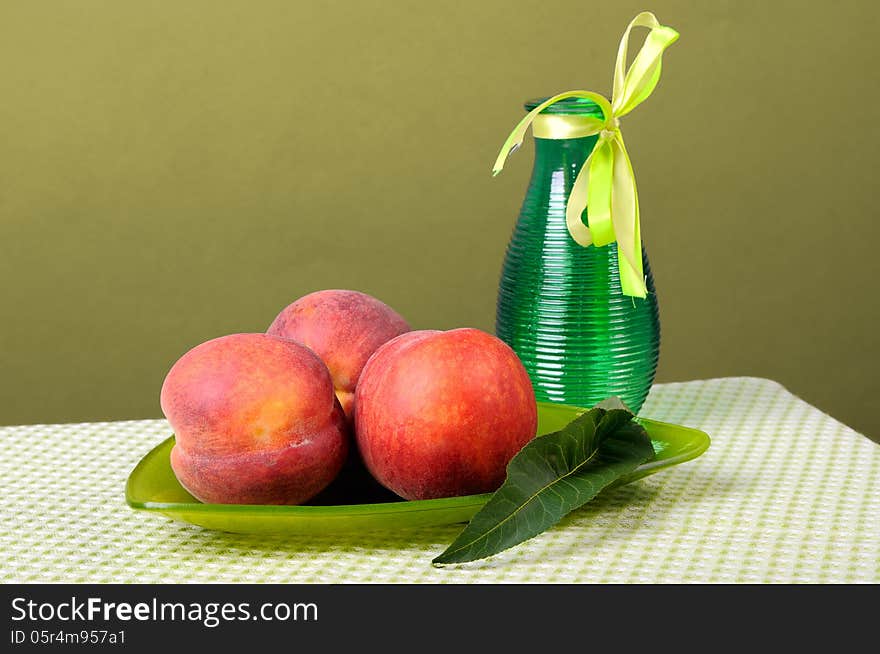 Peaches on a triangular plate and vase