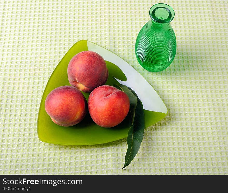 Peaches on a triangular plate and vase