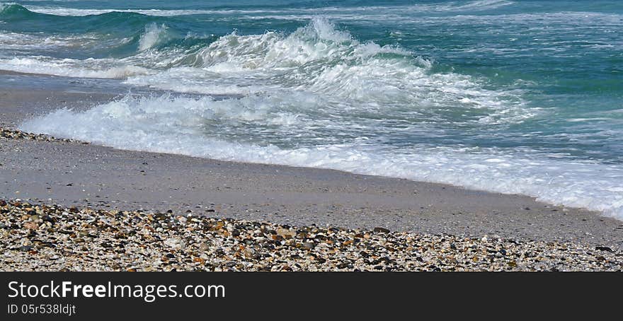 Seascape with pebbles on a beach and atlantic waves. Seascape with pebbles on a beach and atlantic waves