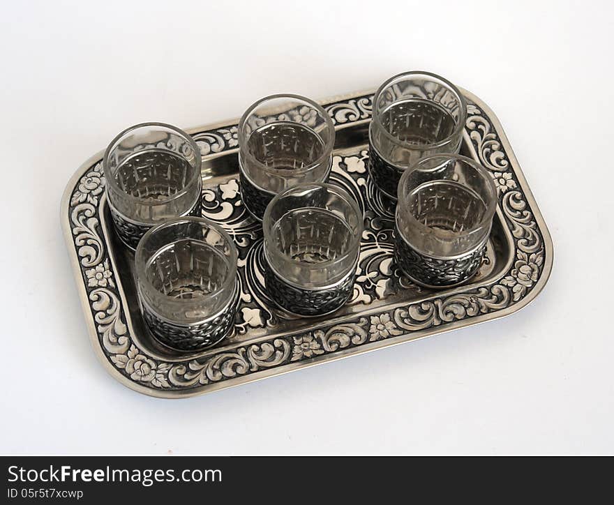 Silver wine-glasses and a tray with pattern special foreshortening. Silver wine-glasses and a tray with pattern special foreshortening