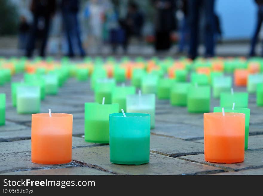 Colored candles on the pavement