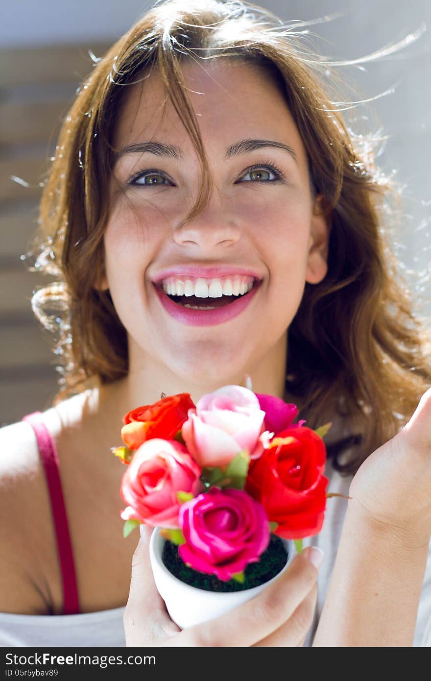 Pretty woman with flowers at home