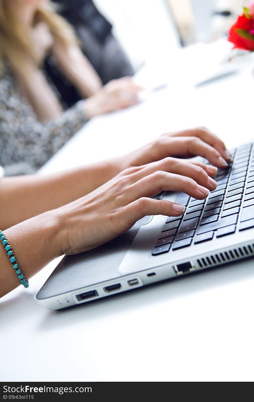 Woman hands typing on laptop