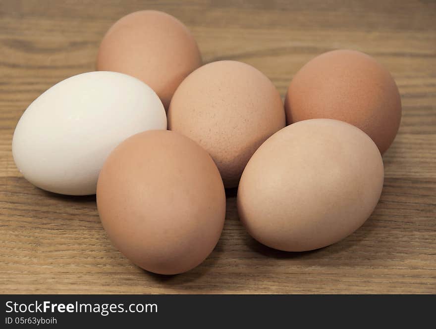 Brown And White Eggs On Grained Wood