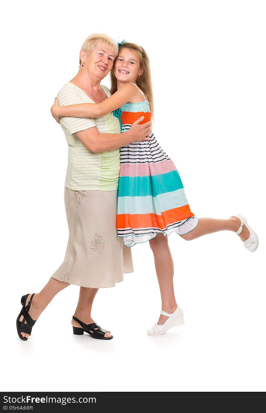 Grandmother with her granddaughter in the studio on a white isolate