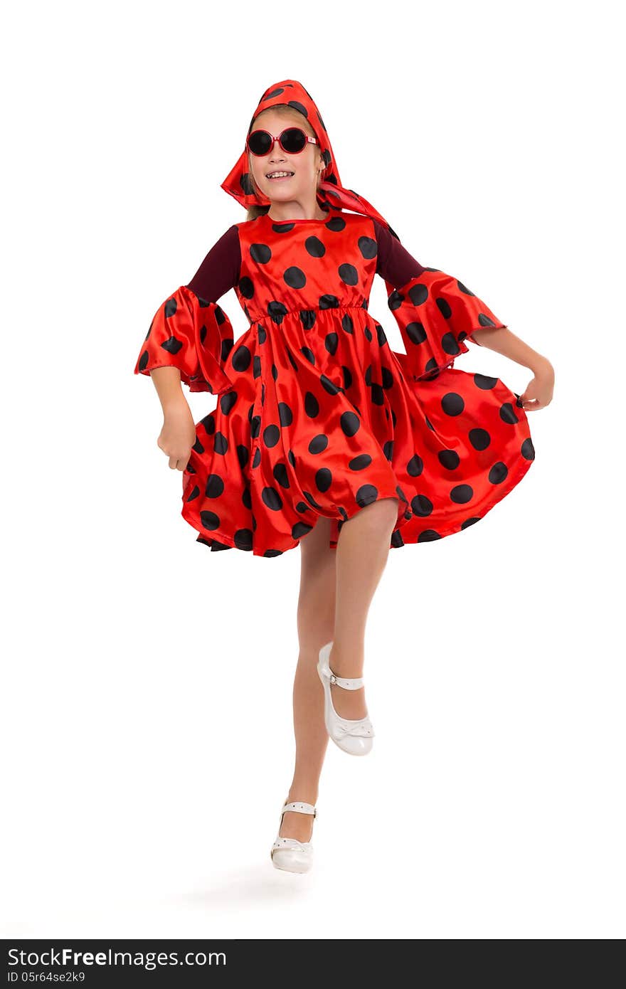 Teen girl dancing in a red polka-dot dress with sunglasses