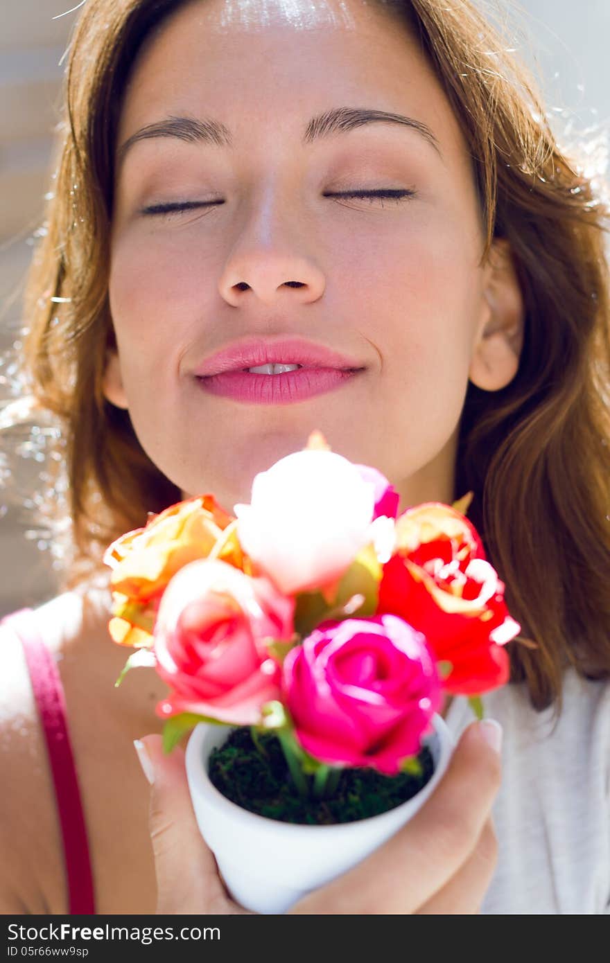 Pretty woman with flowers at home