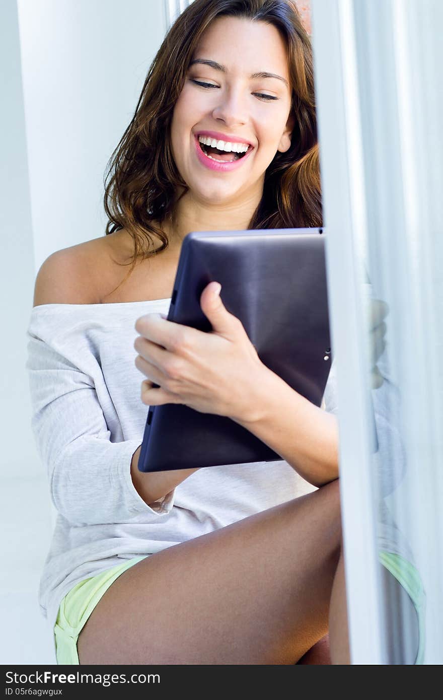 Pretty woman with tablet at home