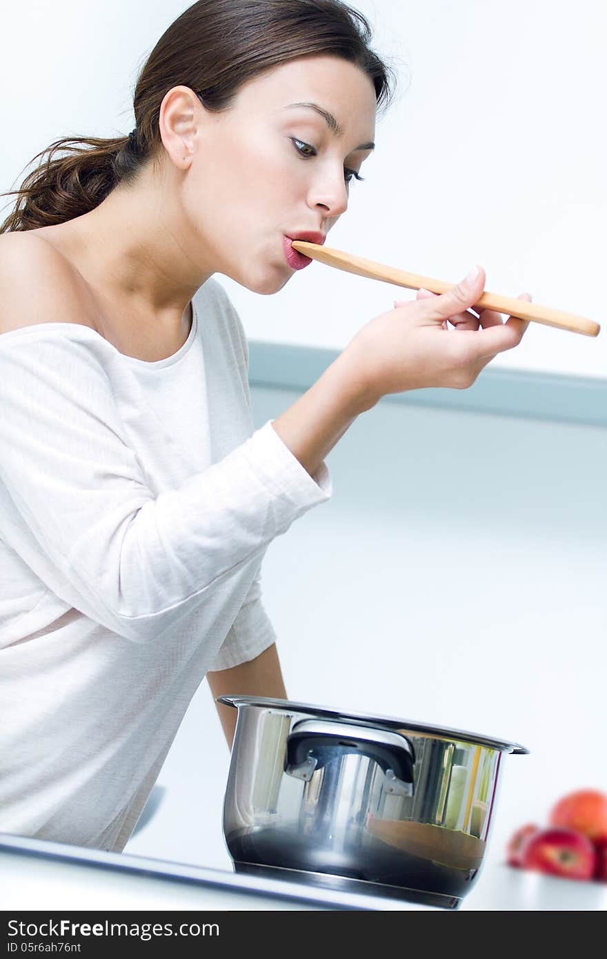 Beautiful Woman Cooking At The Kitchen