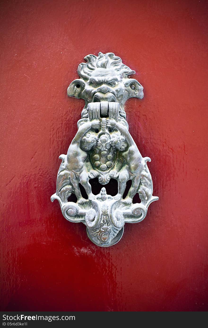 Gothic door knocker on red door