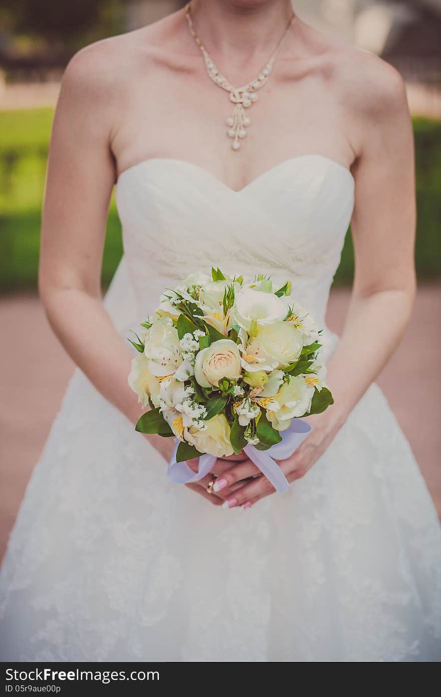 Bridal bouquet of flowers in hands of the bride