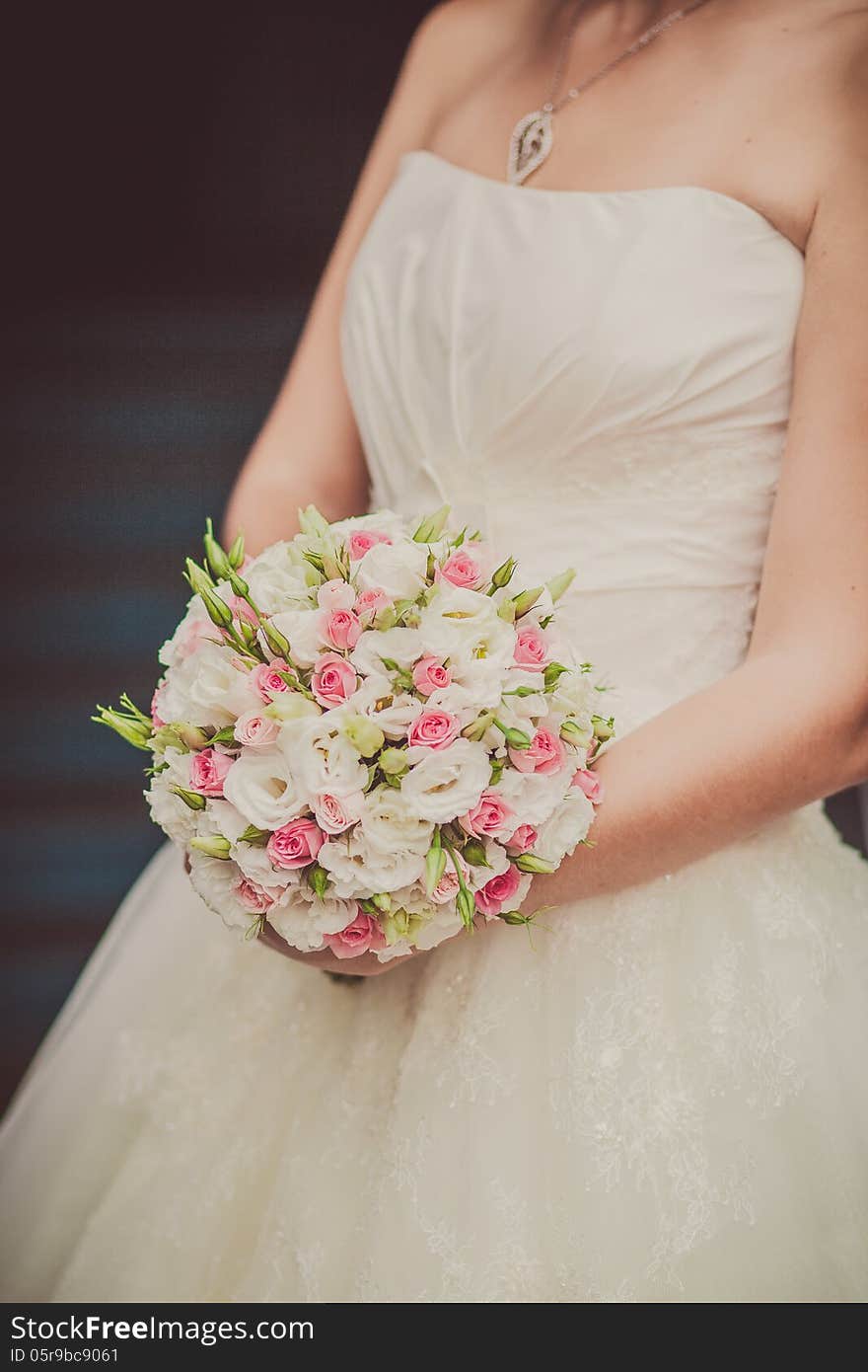 Bridal bouquet of flowers in hands of the bride