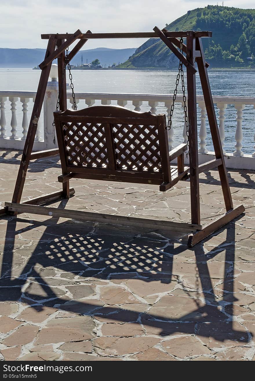 Wooden swing on the promenade overlooking the Angara source